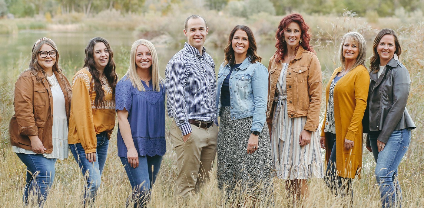 Idaho Falls dentist and team at Cline Family and Cosmetic Dentistry standing in grass
